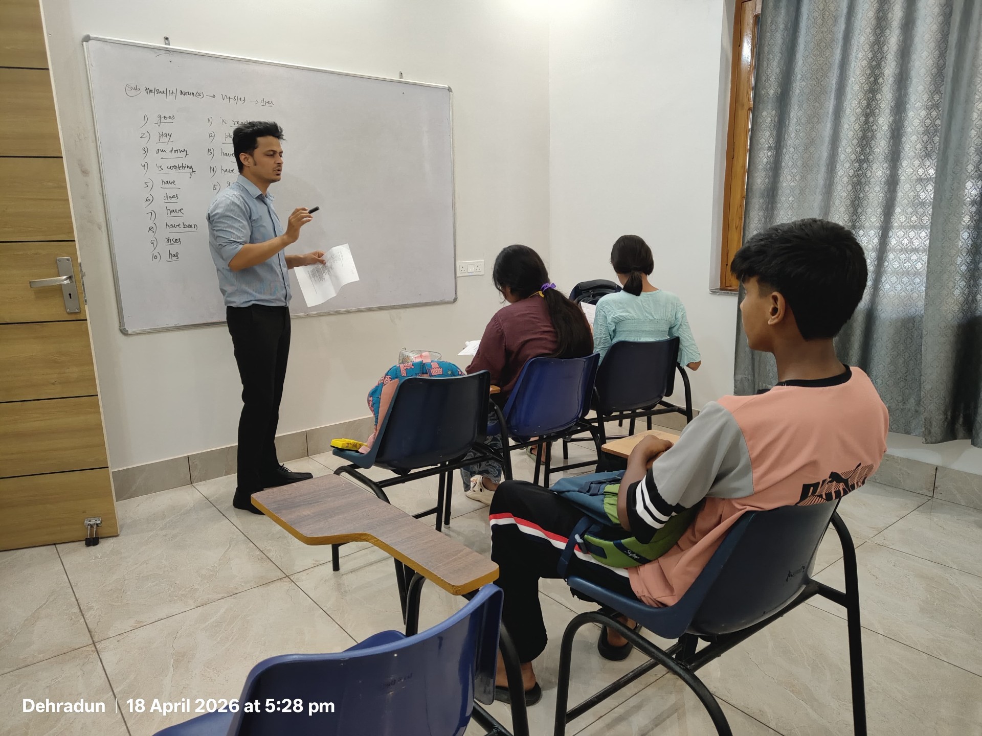 Teacher explaining at board